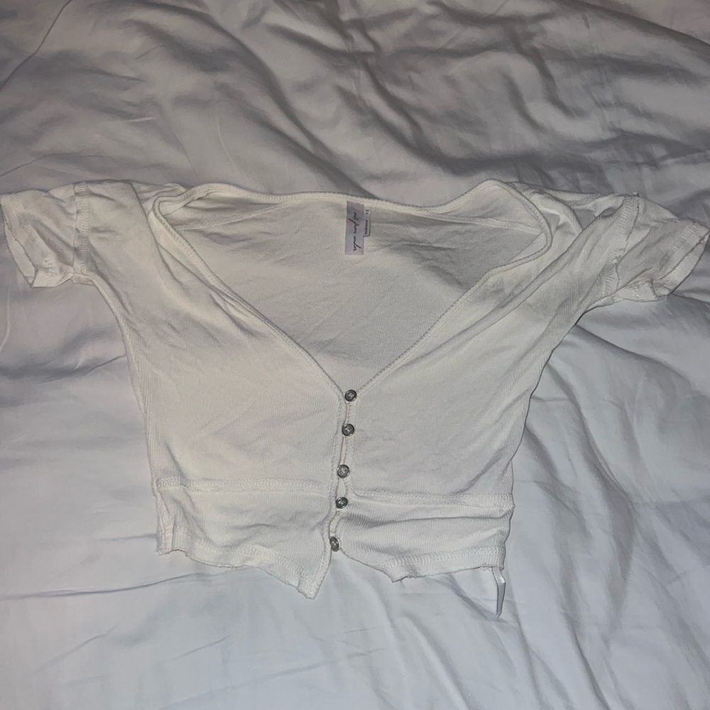 Out from under Urban white button top.